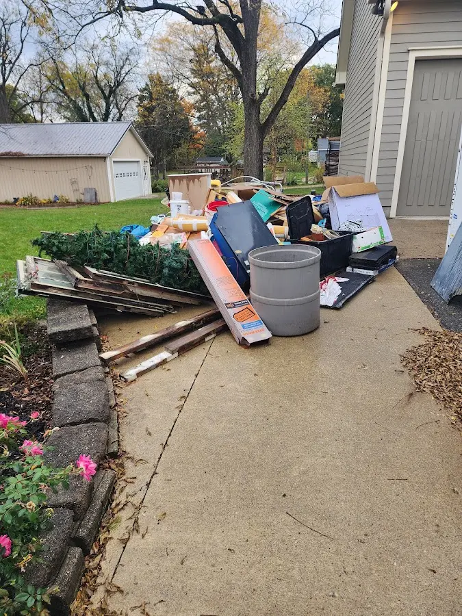 Dumpster being loaded with debris for Roofing Dumpster Rental in Orofino